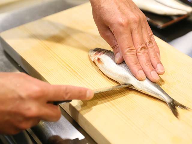 魚をさばく店主